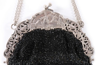 Lot 93 - A beaded purse with ornate continental silver...