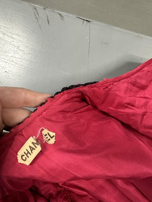 Lot 35 - A Chanel couture raspberry-pink tweed suit, circa 1960