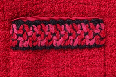 Lot 35 - A Chanel couture raspberry-pink tweed suit, circa 1960