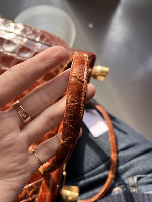 Lot 67 - A brown crocodile handbag, circa 1945 used in the film 'Evita', 1996