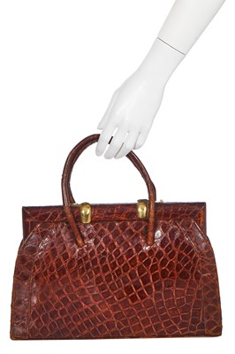 Lot 67 - A brown crocodile handbag, circa 1945 used in the film 'Evita', 1996