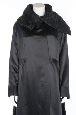 Lot 182 - A Paquin black satin coat, 1919, large woven...