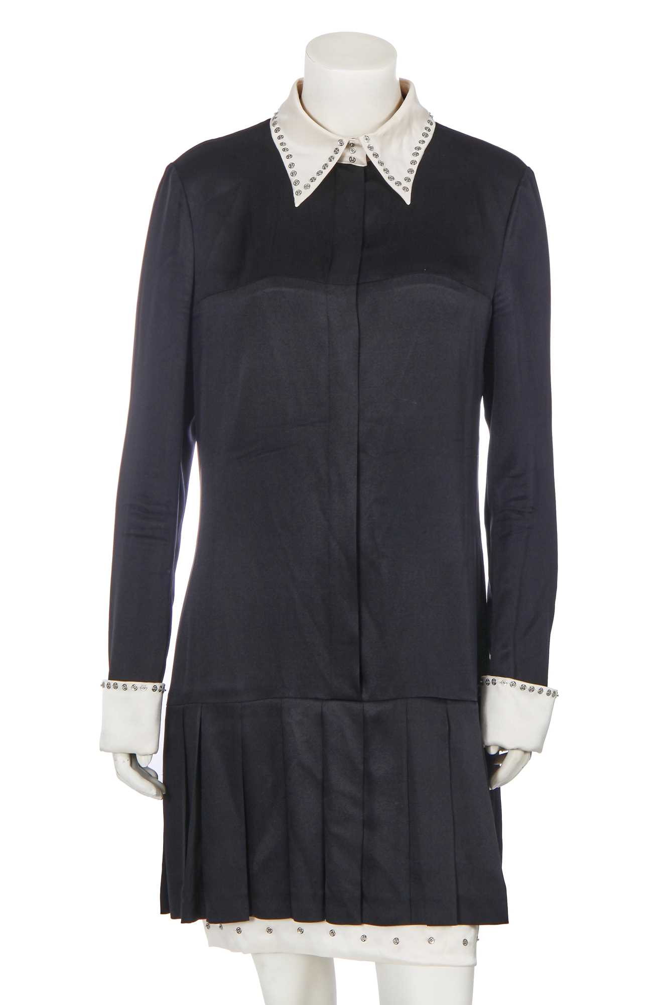 chanel fall/winter 2003 black dress with white collar and cuffs annehathaway as #andysachs in #thedevilwearsprada (2006) is wearing: @chanel fall 2003 RTW Black Mini Dress (Second hand prices vary, Was previously listed and sold on @therealreal for 1,325$) @viviennewestwood x Squiggle Shoulder
