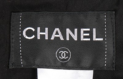 Lot 67 - A Chanel black wool and silver sequinned suit,...