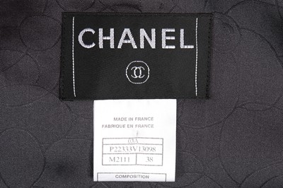 Lot 42 - A Chanel purple tweed suit, Autumn 2003,...