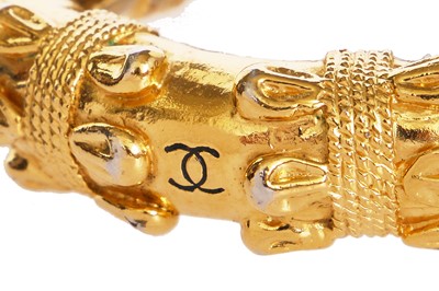 Lot 21 - A Chanel gold tone bangle, late 1970s