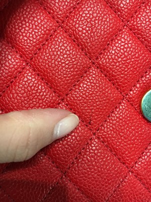 Lot 43 - A Chanel red caviar leather quilted small CC filigree flap bag, 2016-2017