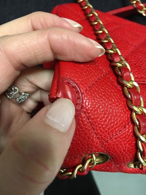 Lot 43 - A Chanel red caviar leather quilted small CC filigree flap bag, 2016-2017