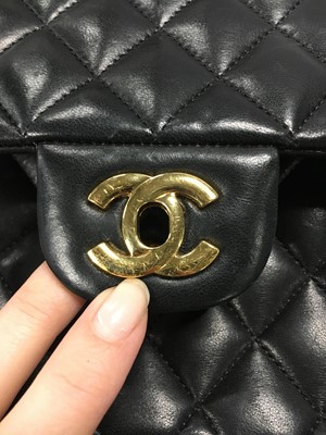 Lot 48 - A Chanel quilted black lambskin leather classic double flap bag, 2010-2011