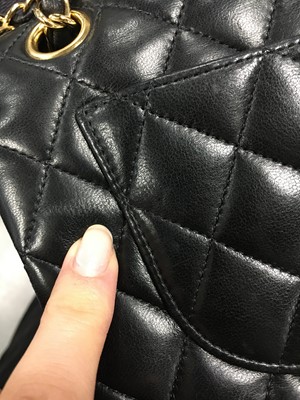 Lot 48 - A Chanel quilted black lambskin leather classic double flap bag, 2010-2011