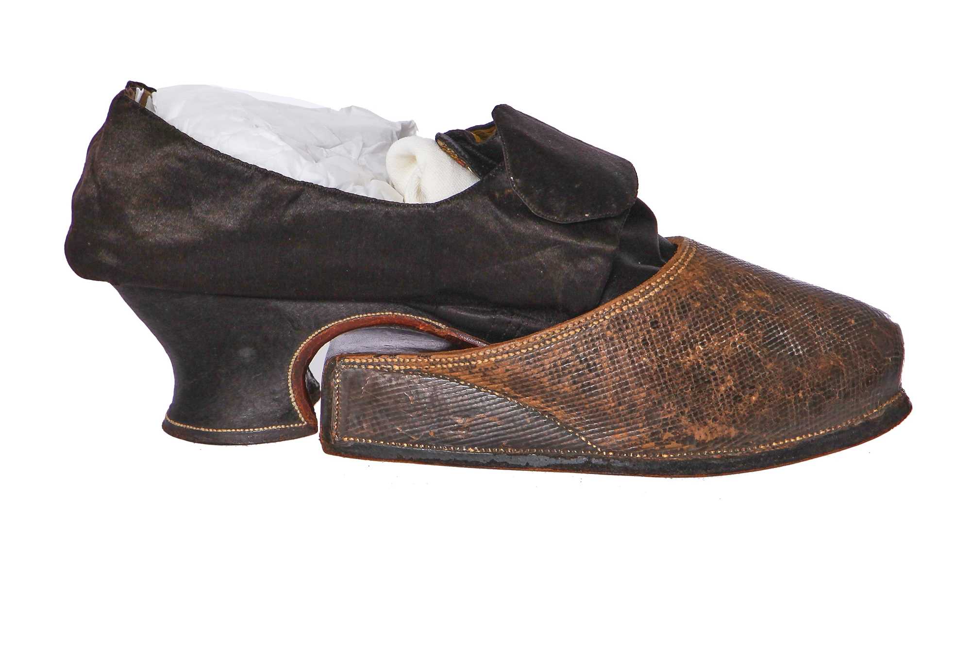 Lot 423 - A pair of black satin shoes and a pair of unusual brown leather pattens, 1770-1780