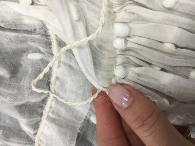 Lot 36 - A rare embroidered white spotted muslin tablier dress, French, circa 1802