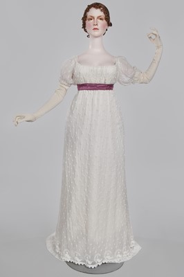 Lot 36 - A rare embroidered white spotted muslin tablier dress, French, circa 1802