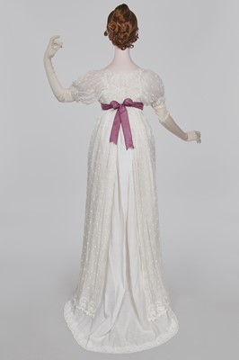 Lot 36 - A rare embroidered white spotted muslin tablier dress, French, circa 1802