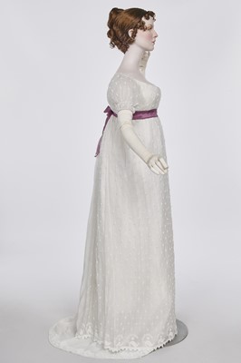 Lot 36 - A rare embroidered white spotted muslin tablier dress, French, circa 1802