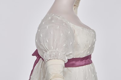 Lot 36 - A rare embroidered white spotted muslin tablier dress, French, circa 1802