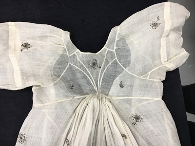 Lot 10 - A fine embroidered and spangled white linen evening gown, French, circa 1796