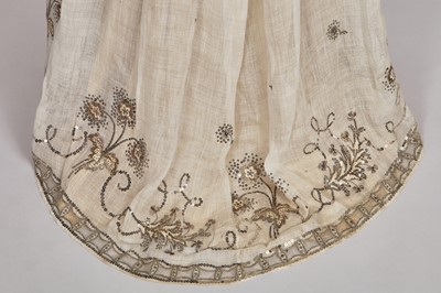 Lot 10 - A fine embroidered and spangled white linen evening gown, French, circa 1796