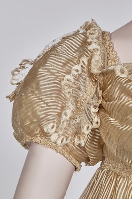 Lot 60 - A striped gold silk gauze ball gown, English, circa 1810