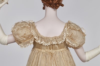 Lot 60 - A striped gold silk gauze ball gown, English, circa 1810