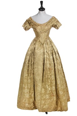 Lot 672 - A green figured silk brocade evening gown, circa 1845