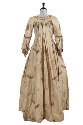 Lot 883 - A beige brocaded silk robe à la Polonaise, 1765-70