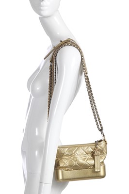 Lot 10 - A Chanel by Karl Lagerfeld small gold leather Gabrielle hobo bag, circa 2017