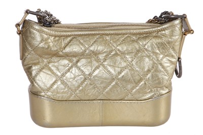 Lot 10 - A Chanel by Karl Lagerfeld small gold leather Gabrielle hobo bag, circa 2017