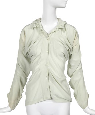 Lot 231 - A John Galliano eau de nil 'circle cut' silk blouse, circa 1987