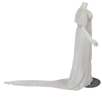 Lot 511 - An unusual cotton gauze gown with long pointed train, circa 1805