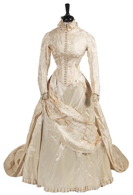 Lot 724 - An ivory damask satin bridal gown, 1883-85