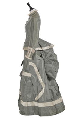 Lot 842 - A contrasting aquamarine silk and grey satin reception gown, circa 1875
