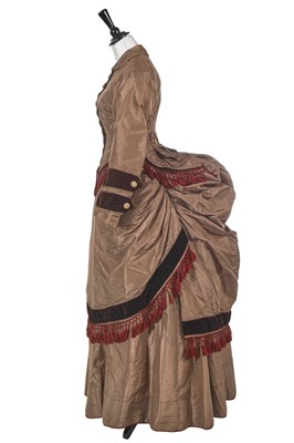 Lot 729 - A pale brown faille and dark brown velvet en tablier gown, 1870-73