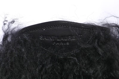 Lot 104 - A pair of Saint Laurent by Anthony Vaccarello black Mongolian sheepskin fur boots, circa 2019