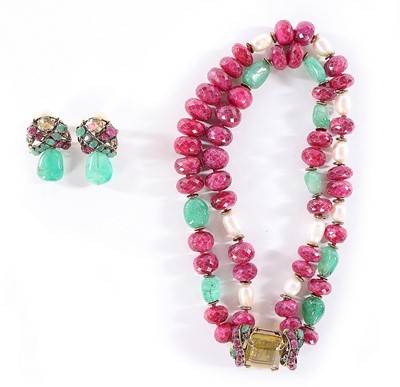 Lot 100 - An Iradj Moini raw emerald, facetted raw ruby...
