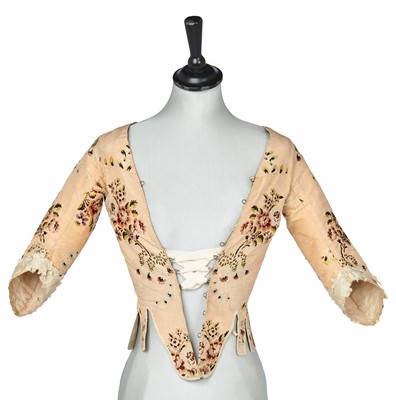 Lot 744 - A brocaded peach silk bodice, probably French, 1770s