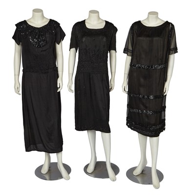 Lot 697 - Three black beaded dresses, early 1920s