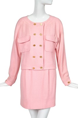 Lot 49 - A Chanel by Karl Lagerfeld pink bouclé suit, circa 1987-88