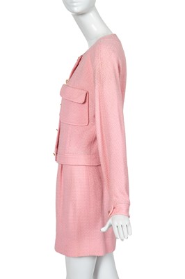 Lot 49 - A Chanel by Karl Lagerfeld pink bouclé suit, circa 1987-88