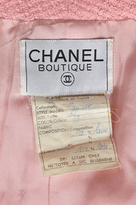 Lot 49 - A Chanel by Karl Lagerfeld pink bouclé suit, circa 1987-88