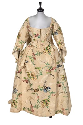 Lot 536 - A brocaded Spitalfields silk robe à la Française, the fabric 1755-1750, but later altered