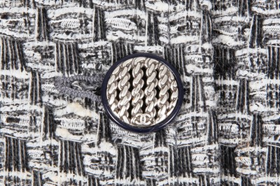 Lot 29 - A Chanel by Karl Lagerfeld black and white tweed suit, circa 2012