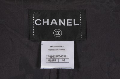Lot 29 - A Chanel by Karl Lagerfeld black and white tweed suit, circa 2012