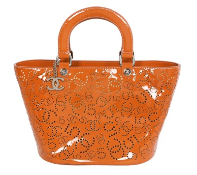 Lot 65 - A Chanel by Karl Lagerfeld punched orange patent leather tote, 2005-2006