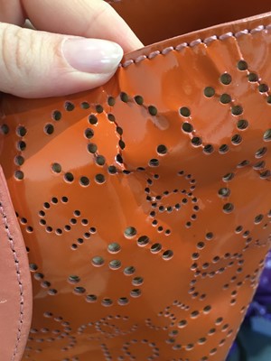 Lot 65 - A Chanel by Karl Lagerfeld punched orange patent leather tote, 2005-2006