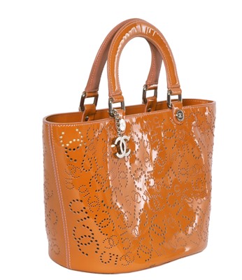 Lot 65 - A Chanel by Karl Lagerfeld punched orange patent leather tote, 2005-2006
