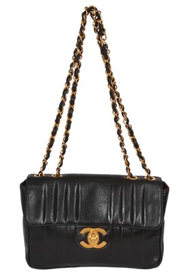 Lot 83 - A Chanel by Karl Lagerfeld jumbo black leather flap bag, 1991-94
