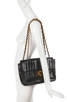 Lot 83 - A Chanel by Karl Lagerfeld jumbo black leather flap bag, 1991-94