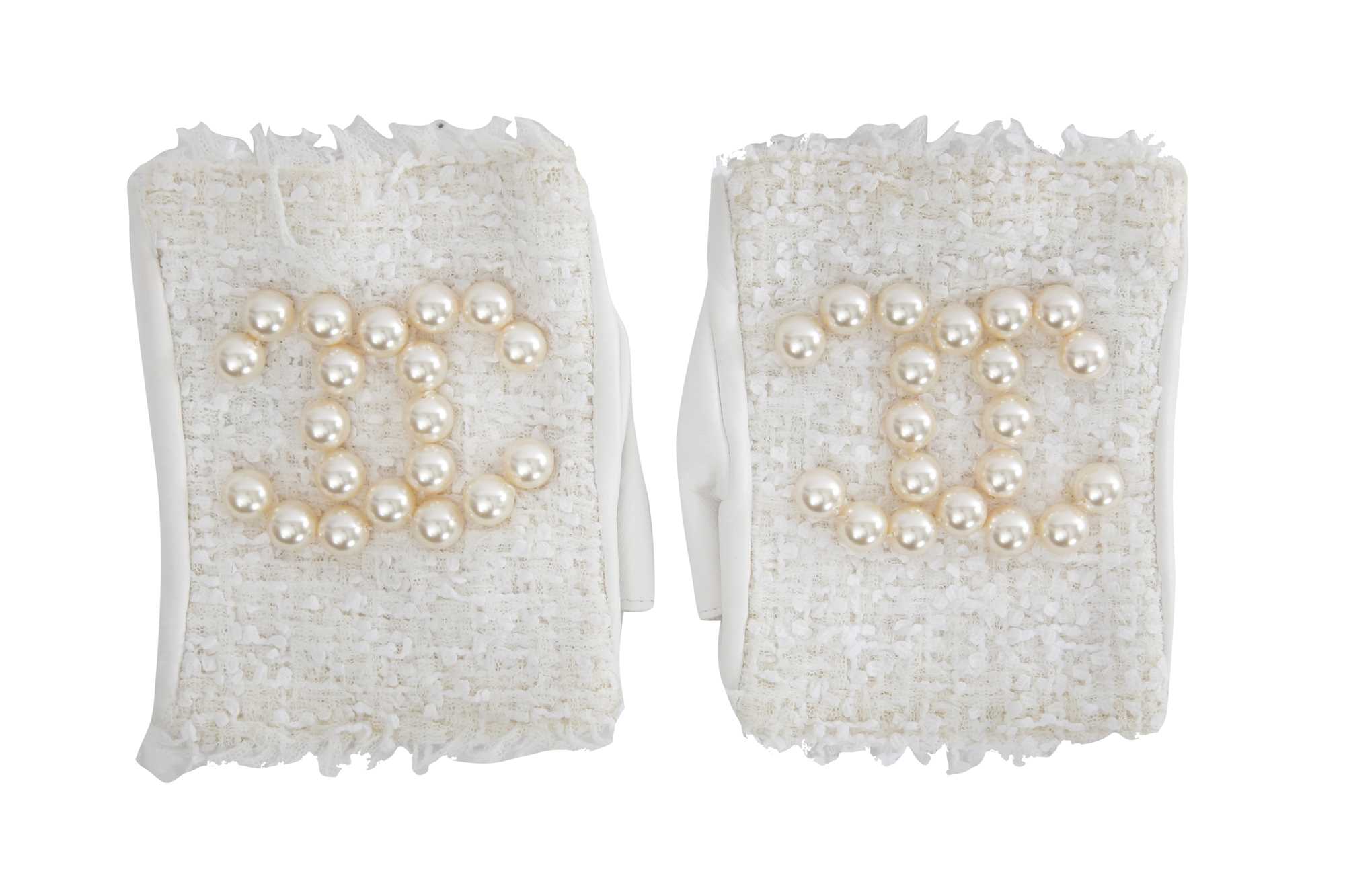 Lot 18 - A pair of Chanel haute couture by Karl Lagerfeld white tweed mitts, Spring-Summer 2014