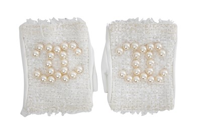 Lot 18 - A pair of Chanel haute couture by Karl Lagerfeld white tweed mitts, Spring-Summer 2014
